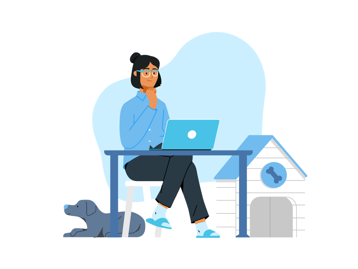 Una persona sentada en un escritorio con una computadora y un perro a su lado